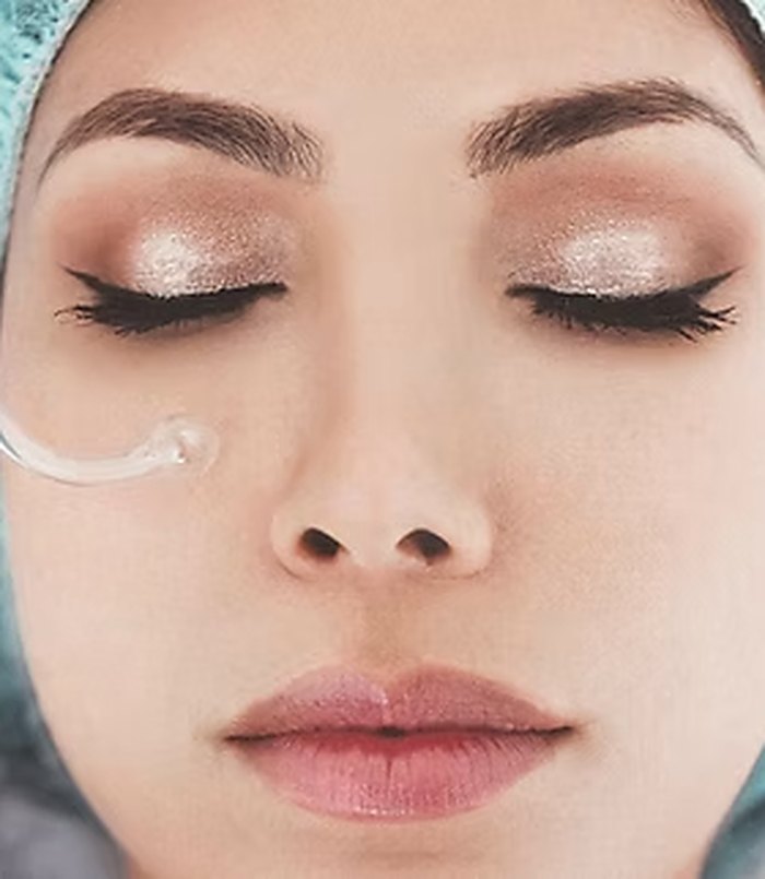 Client with closed eyes during a calming facial